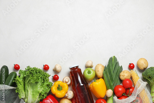 Fototapeta Naklejka Na Ścianę i Meble -  Fresh vegetables and other products on light grey background, flat lay. Space for text