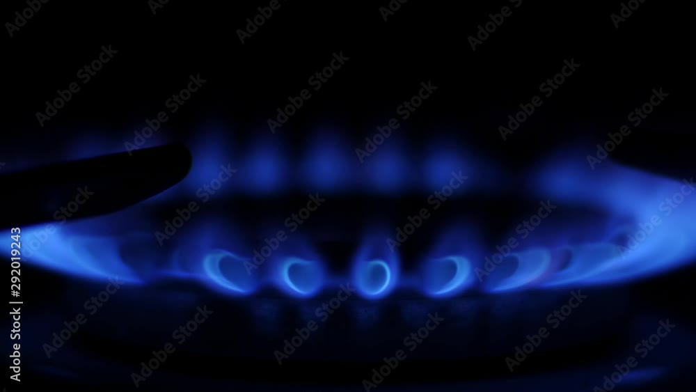Close up ignition of flame on the kitchen stove. Slow motion Close up ignition of flame on the kitchen stove. Slow motion