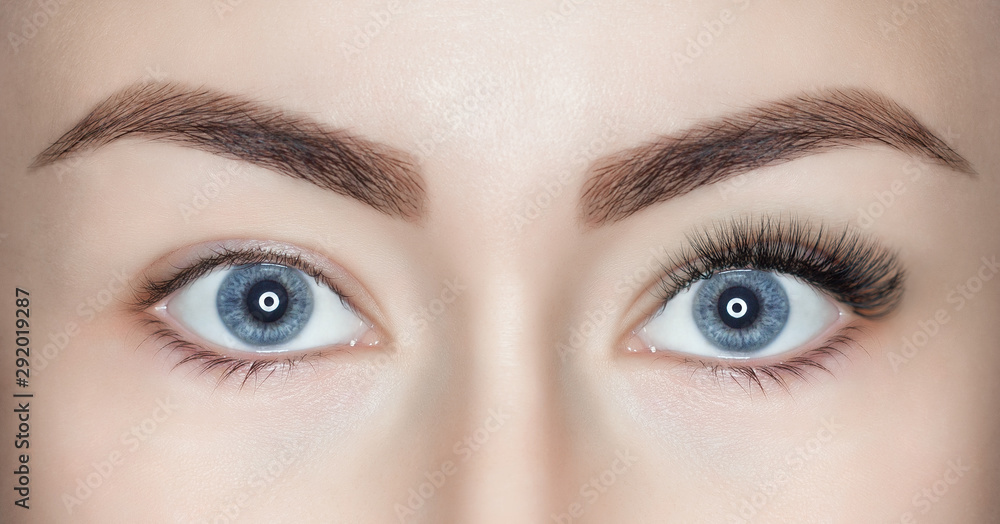 A beautiful woman with long eyelashes in one eye, and on the other, eyelashes are not extended. Eyes close up. A beautiful woman with long eyelashes in one eye, and on the other, eyelashes are not extended. Eyes close up.