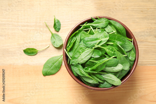 Fresh green healthy spinach on wooden table, top view