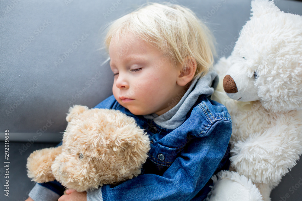Blond toddler boy, sleeping with many teddy bears in the afternoon Blond toddler boy, sleeping with many teddy bears in the afternoon