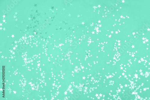White and green stars scattering on mint background.
