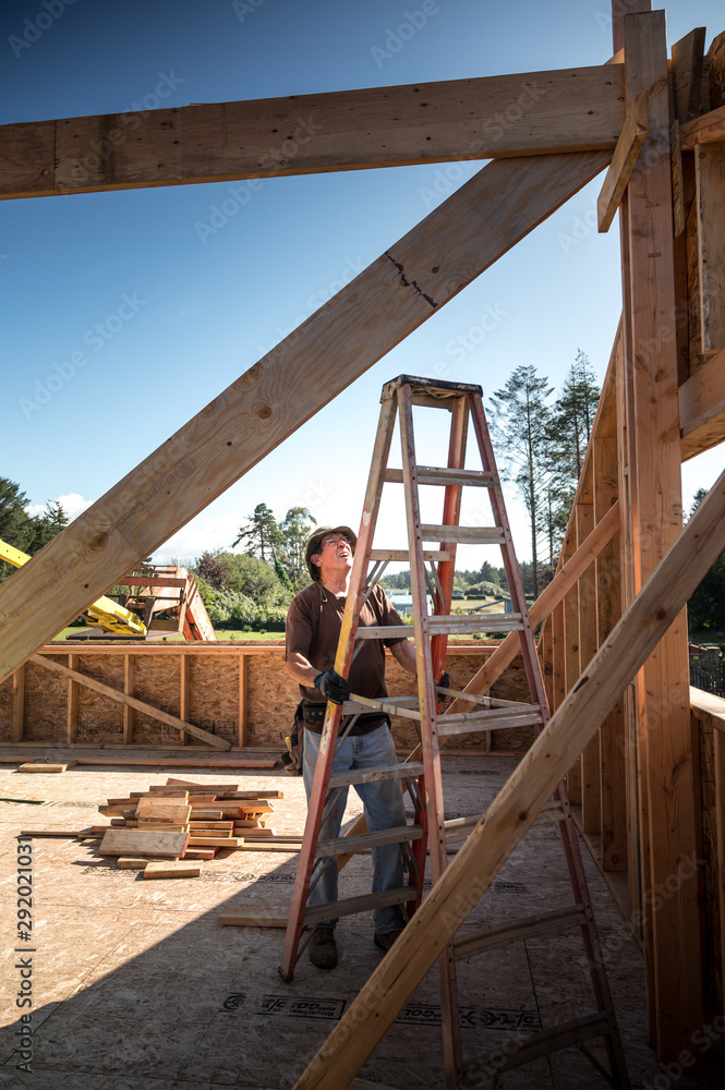 Fototapeta premium New home construction process, skilled roofer 