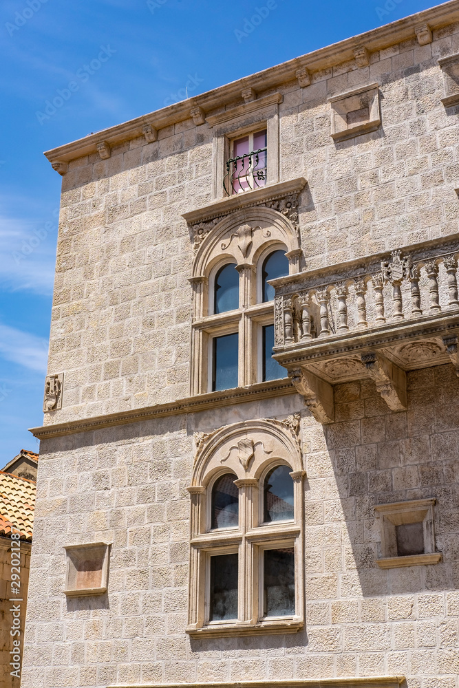 Characteristic stone balcony on old stone house and blue sunny sky in Korcula town, Korcula Island, Dalmatia, Croatia