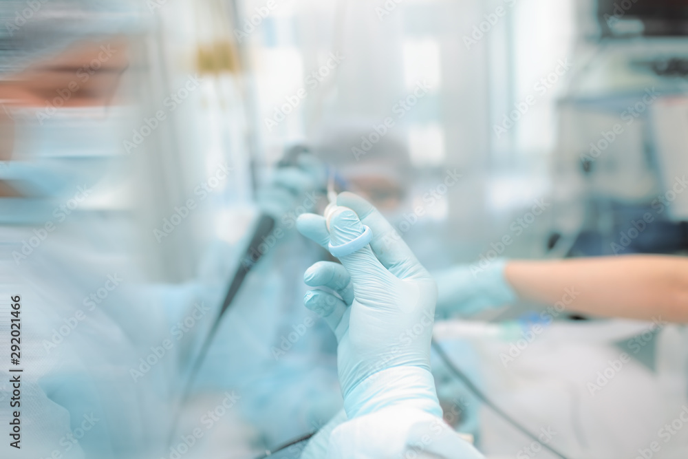 Medical team provides endoscopic procedure to the critical patient, unfocused background. Medical team provides endoscopic procedure to the critical patient, unfocused background.