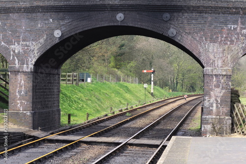 rail tracks under a bridge
