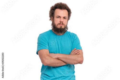 Confident crazy bearded Man with funny Curly Hair posing with crossed arms, isolated on white background. Male with hands folded looking at camera. Emotions and signs concept.