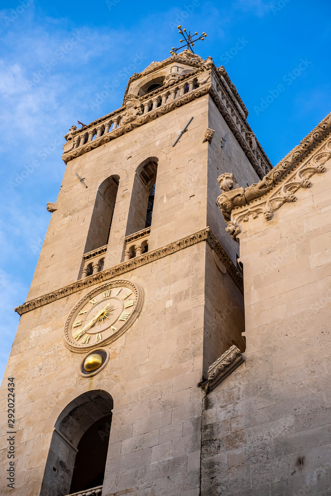 View on exterior of St. Mark’s Cathedral, bell tower and church’s rosette with blue sky in the centre of historic old town of Korcula, Korcula Island, Dalmatia, Croatia 