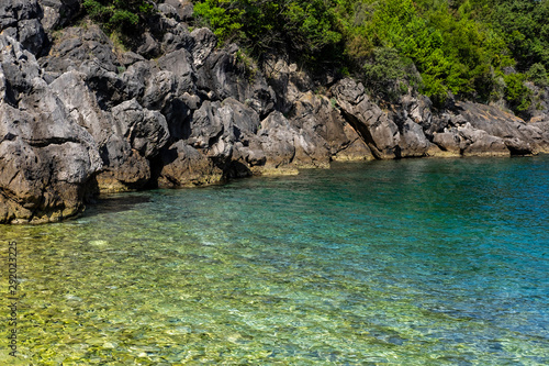 Vaja beach in Racisce, Korcula Island, Dalmatia, Croatia, clear blue sea water, stone beach, green nature, summer holiday, very popular touristic destination 