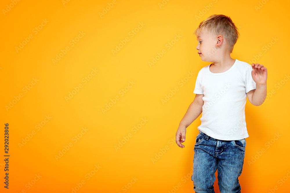 Fashionable little boy posing in jeans. Fashionable little boy posing in jeans.
