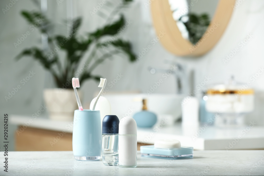 Roll-on deodorants with toiletry on table in bathroom, space for text Roll-on deodorants with toiletry on table in bathroom, space for text