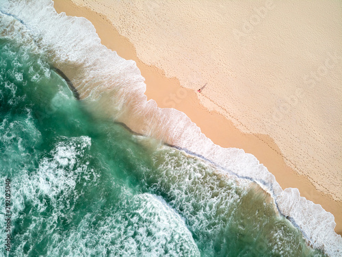 Aerial Photography of Ocean With Person Walking on Beach