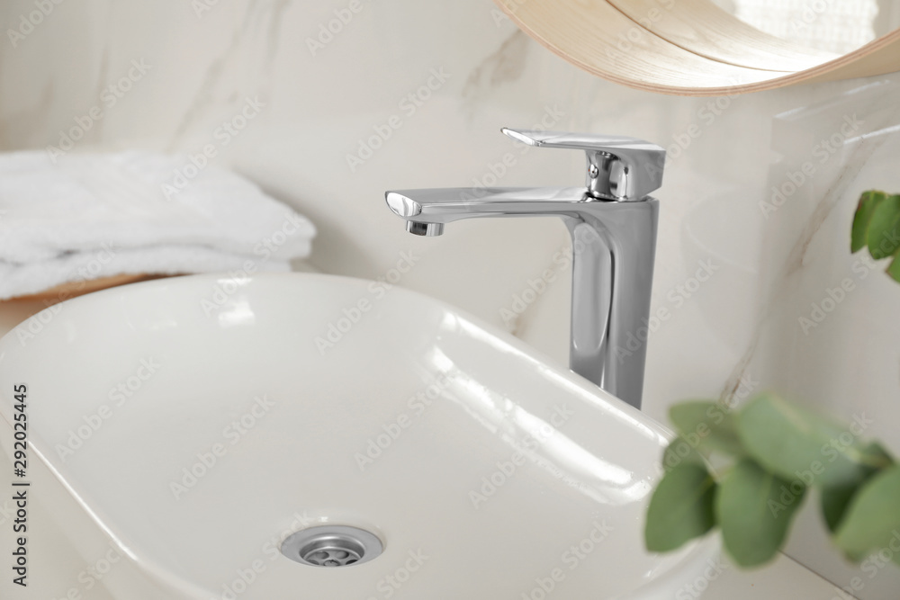 Vessel sink with shiny faucet in bathroom interior Vessel sink with shiny faucet in bathroom interior