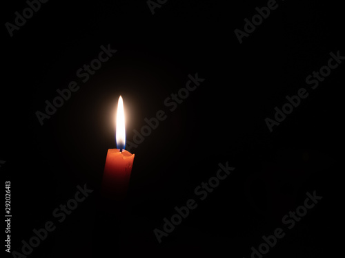 the candle burns in complete darkness