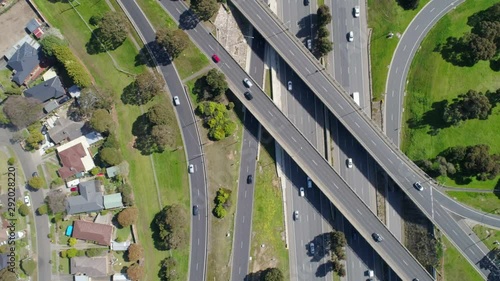 Looking down with slow camera twist at cars driving on busy highway interchange photo