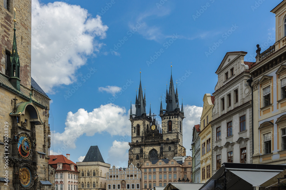 The historical center of Prague. Old Town Square. View from the entrance to the Catholic Church of St. Mary in front of Tyn and the astronomical clock on the left on the old tower