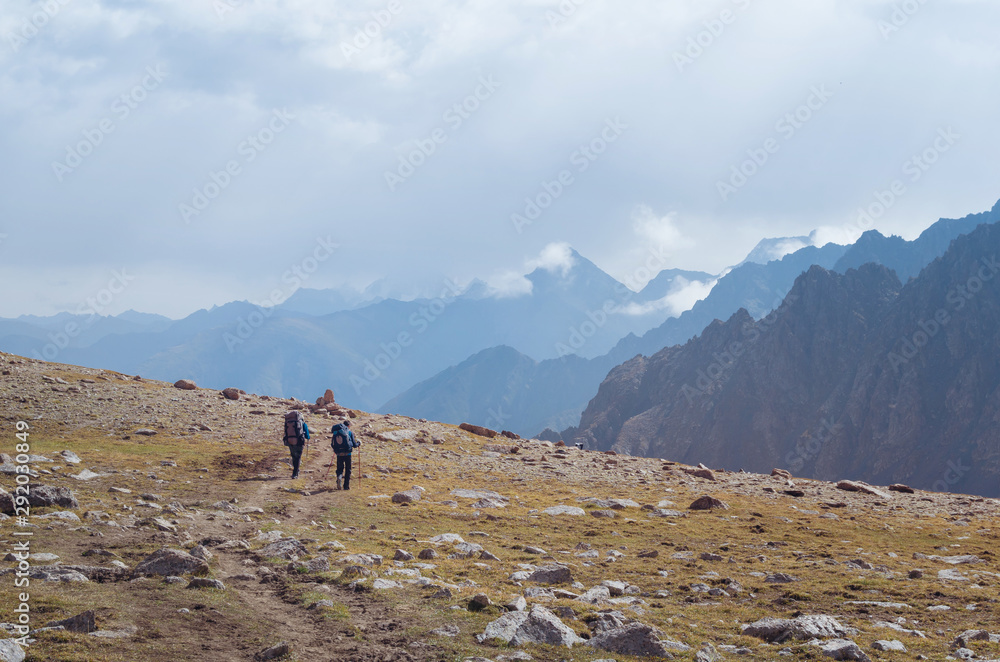 Men walking along a mountain trail