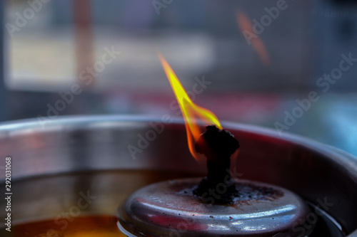 Closeup of candle flame in buddhist temple