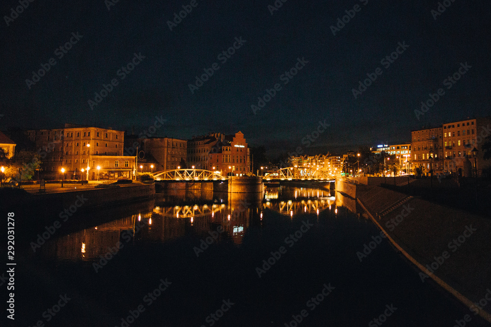 Night scene in Wroclaw. Illuminated old buildings reflect in Oder river.