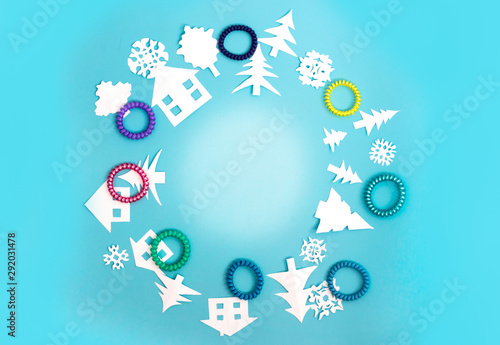 Circle with Christmas decorations and figures of houses, Christmas trees and snowflakes on blue background