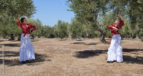 Two girls practice flamenco in an olive grove