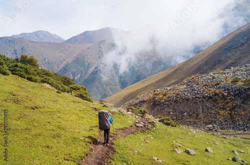 Anonymous man walking along a mountain trail
