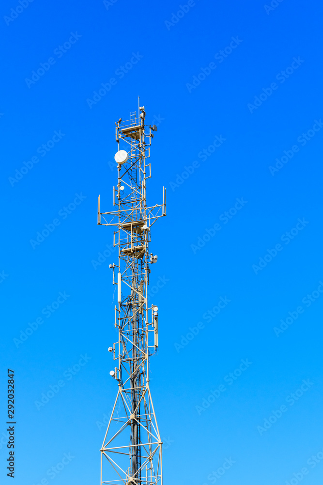 Telecommunication tower with the antennas or wireless Communication antenna transmitter against blue sky Telecommunication tower with the antennas or wireless Communication antenna transmitter against blue sky