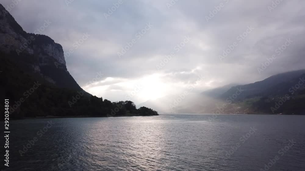 Sunrise On Lake Walensee In The Swiss Alps - Aerial drone dolly out tilt down ascending shot Sunrise On Lake Walensee In The Swiss Alps - Aerial drone dolly out tilt down ascending shot