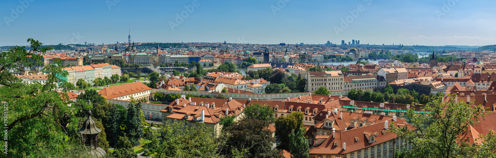 summer panoramic view of the historical areas of Prague, the Vltava River with bridges from a hill from Prague Castle through the roofs of the old town at the foot of the castle