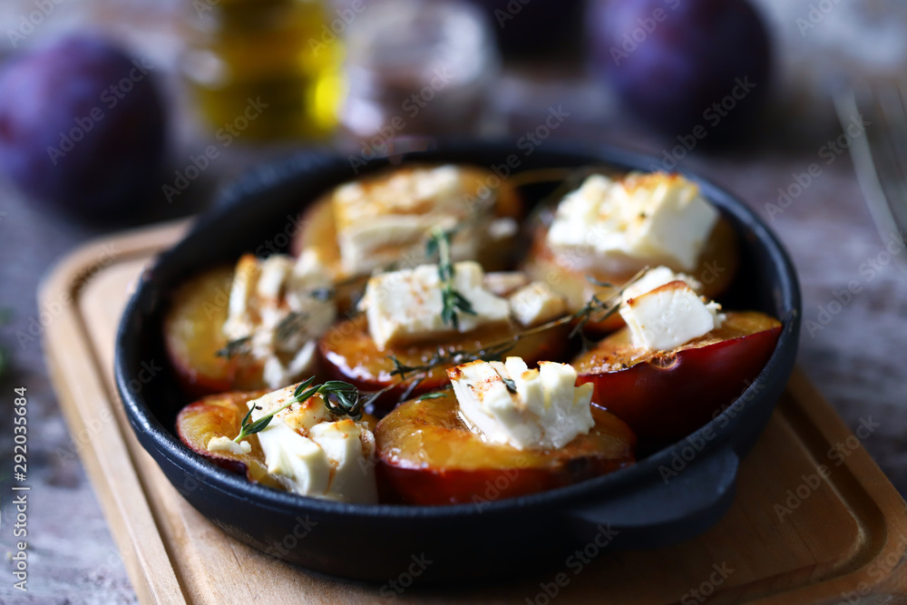 Baked plums with feta cheese. French cuisine Healthy organic food.