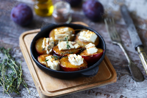 Baked plums with feta cheese. French cuisine Healthy organic food.