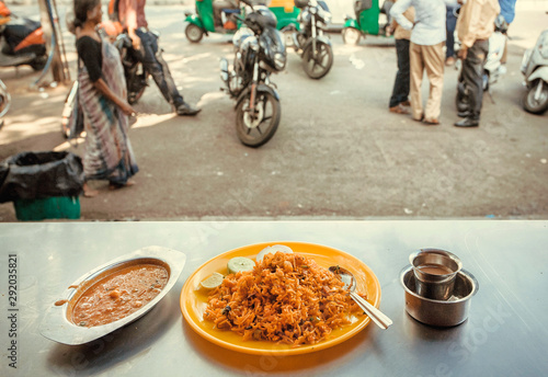 Indian food in traditional style. Curry and rice in street cafe in city of India