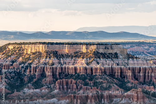 High angle view from Bryce Point overlook of hoodoos rock formations in Bryce Canyon National Park at sunset with sunlight