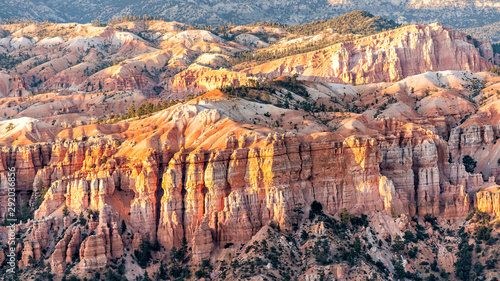 Panoramic closeup view from Bryce Point overlook of orange colorful hoodoos rock formations in Bryce Canyon National Park at sunset with patterns