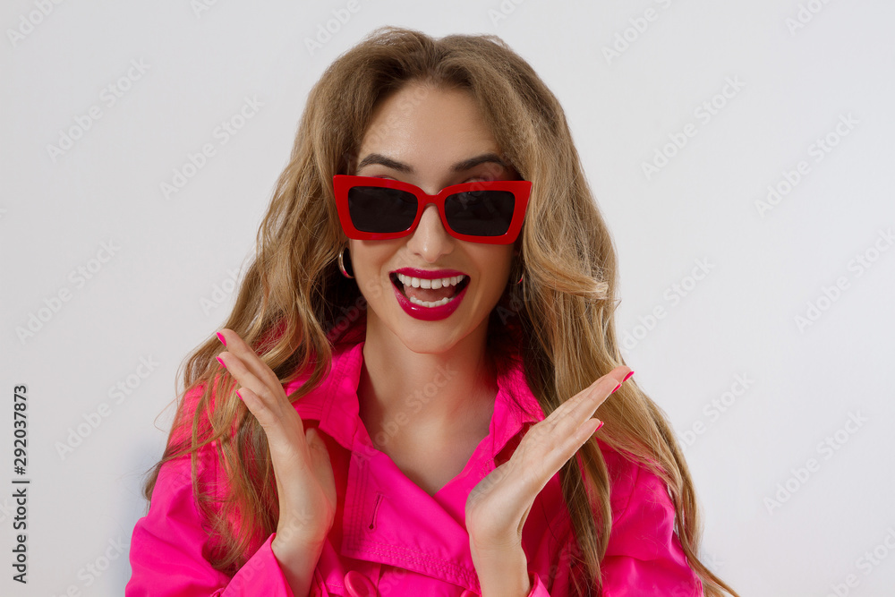 Happy, shock, excited woman face closeup. Girl in bright pink autumn clothes, red sunglasses isolated on white background, copy space. Beautiful female surprised, cheerful. Fun funny model screaming Happy, shock, excited woman face closeup. Girl in bright pink autumn clothes, red sunglasses isolated on white background, copy space. Beautiful female surprised, cheerful. Fun funny model screaming