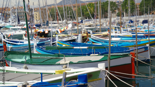 Many Rowboats and Sailboats Used for Fishing Docked in a Port  Each Boat has it's own Unique Colorful Look © MotionLoop