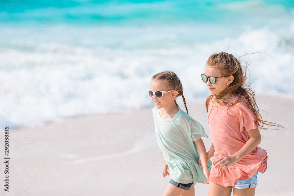 Two little girls together on the beach on vacation Two little girls together on the beach on vacation
