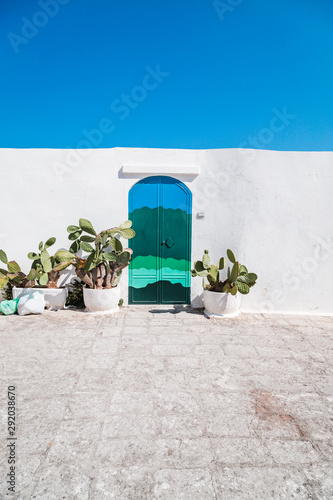 Ostuni, Italy - August 2019: Famous colored door in the historic center of the white city of Ostuni in Puglia, on a day in August