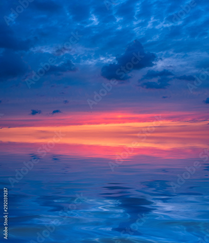 Sunset in the form of three colors of the sky: orange, purple, magenta over the sea. © Sviatoslav Khomiakov