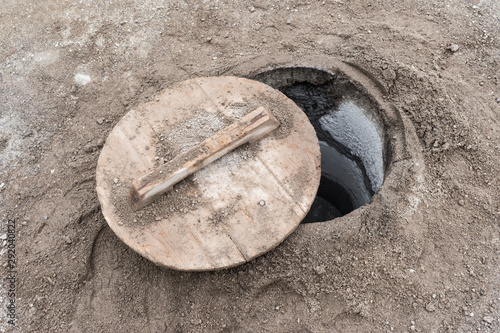 Closeup of a lid partially covering a hole in which Cozido das Furnas is cooked on the island of São Miguel in the Azores archipelago. The traditional cozido is cooked by the natural heat of the earth