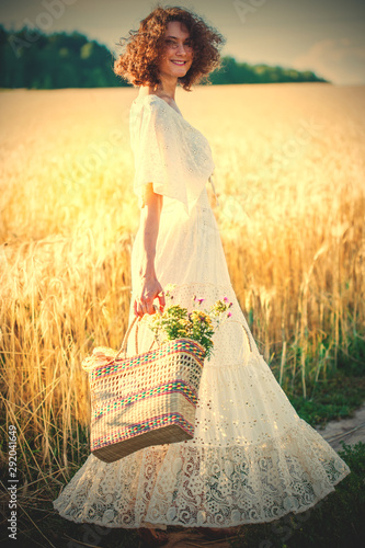 beautiful smiling woman in white syled dress outdoors photo