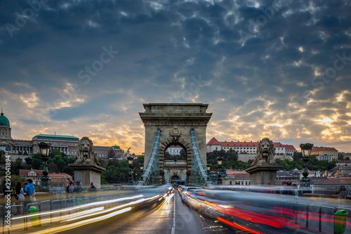 Budapest, Hungary - Heavy afternoon traffic on the iconic Szechenyi Chain Bridge at sunset with beautiful sky and clouds