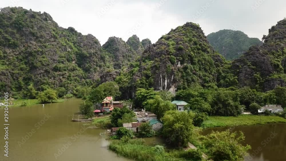 Aerial ascending shot over rocky mountains in Ninh Binh, north of Vietnam. Aerial ascending shot over rocky mountains in Ninh Binh, north of Vietnam.