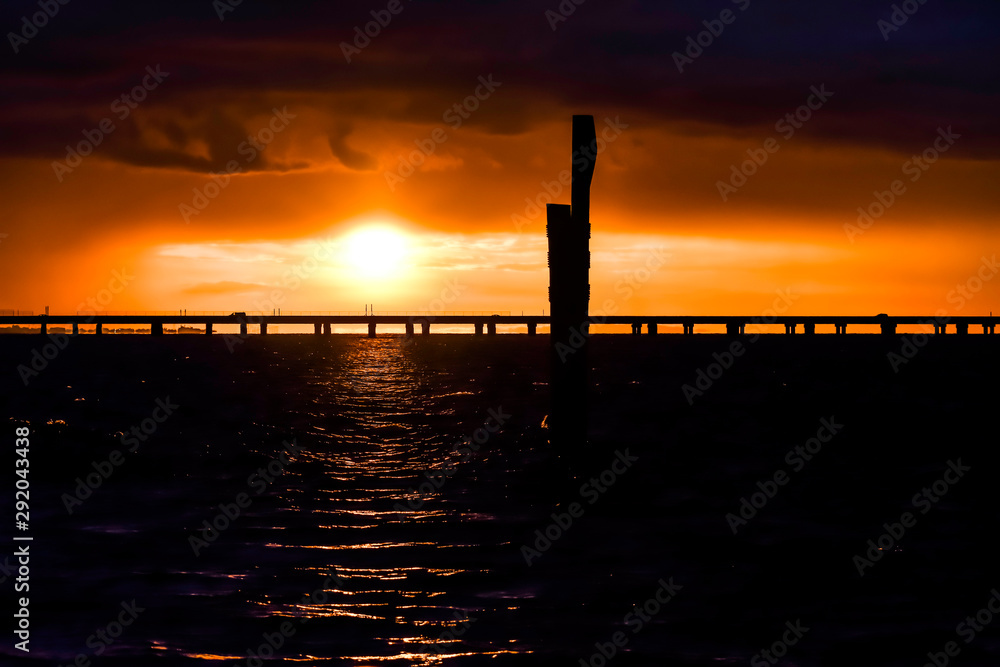 sunset over bridge on a lake
