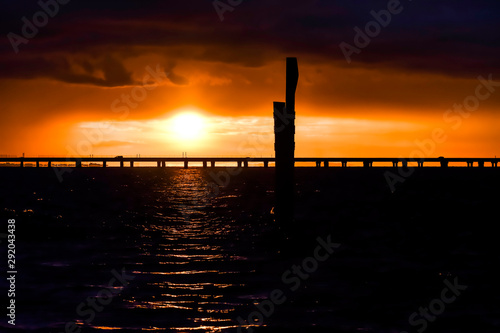 sunset over bridge on a lake