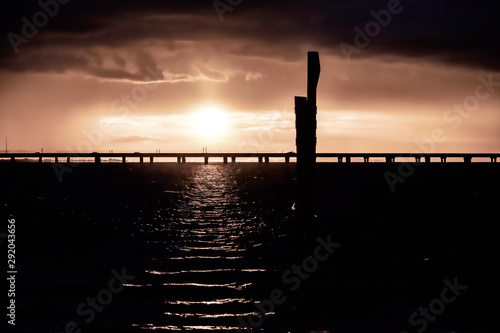 sunset over bridge on a lake