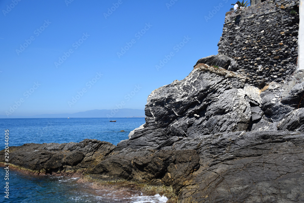 Seascape view with rocky beach in the foreground