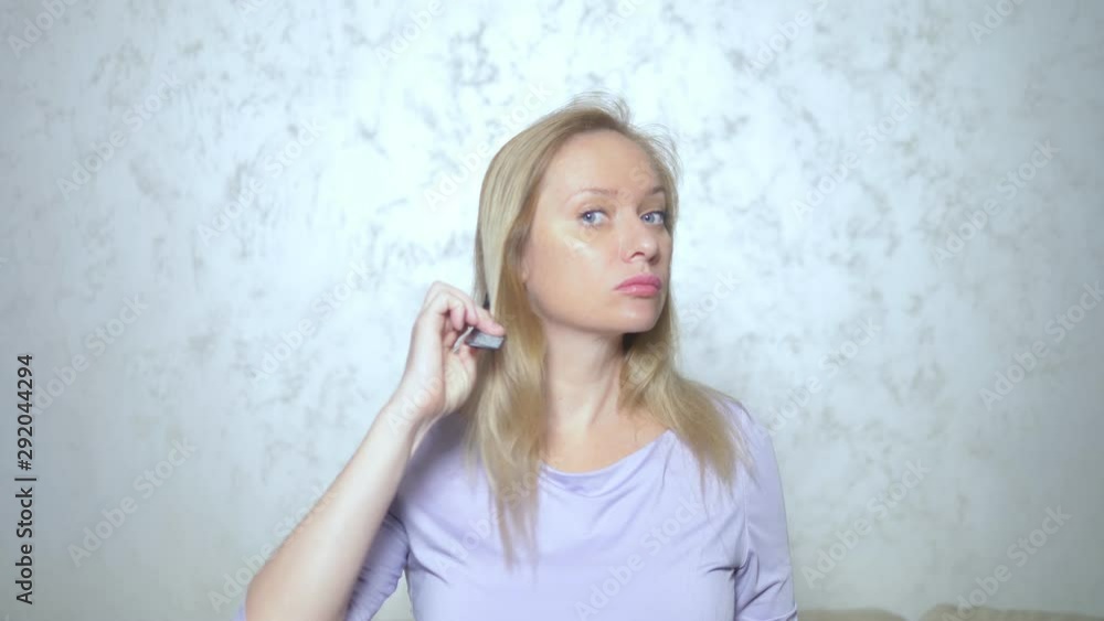 hair loss problems, alopecia. the woman has shreds of hair during combing. lost hair remains in her hands hair loss problems, alopecia. the woman has shreds of hair during combing. lost hair remains in her hands