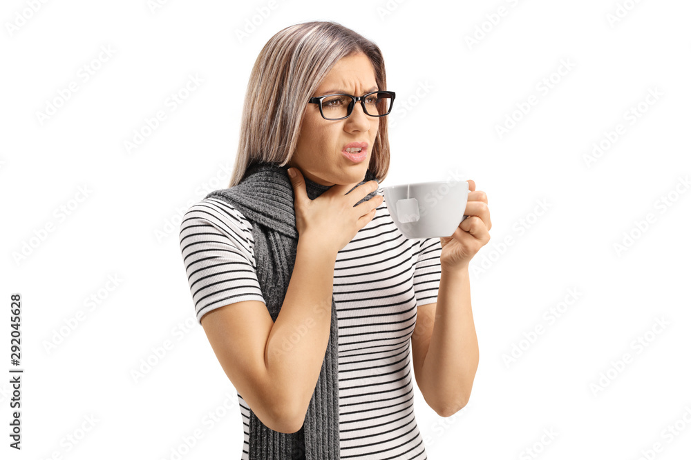 Young woman with a sore throat having a tea Young woman with a sore throat having a tea