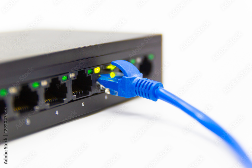The blue network cables connect port switch on white table concept internet network connection The blue network cables connect port switch on white table concept internet network connection